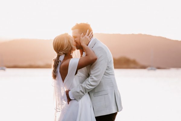 Bride & Groom kiss at sunset