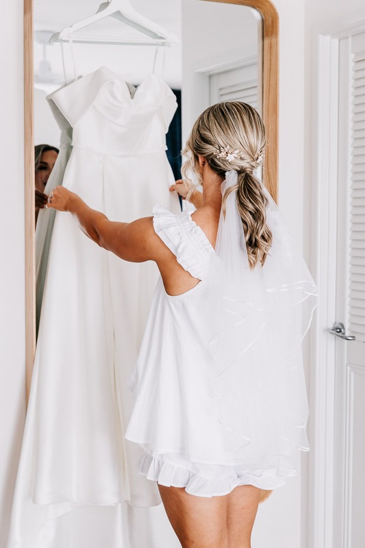Bride admiring gown