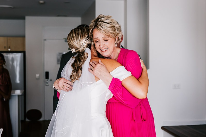 Bride hugs mother