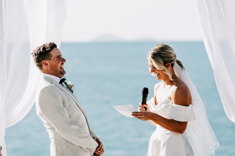 Bride & Groom laugh with each other at ceremony