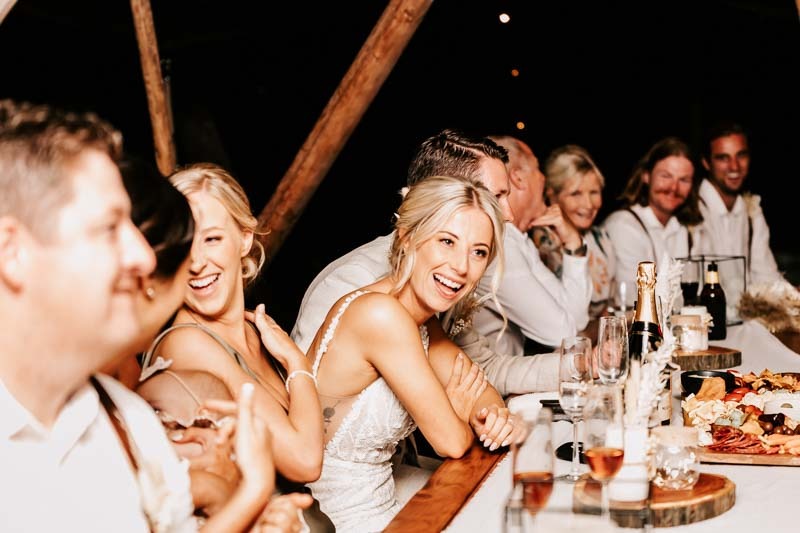 Bride laughs at reception