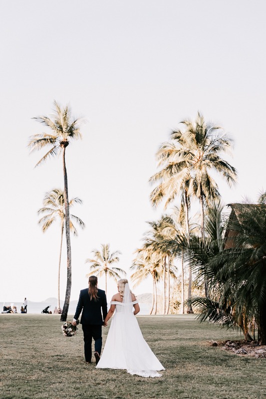 Bride & Groom walk towards palm trees