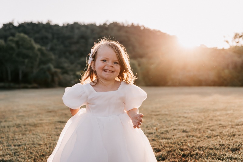 Little girl smiles in sun
