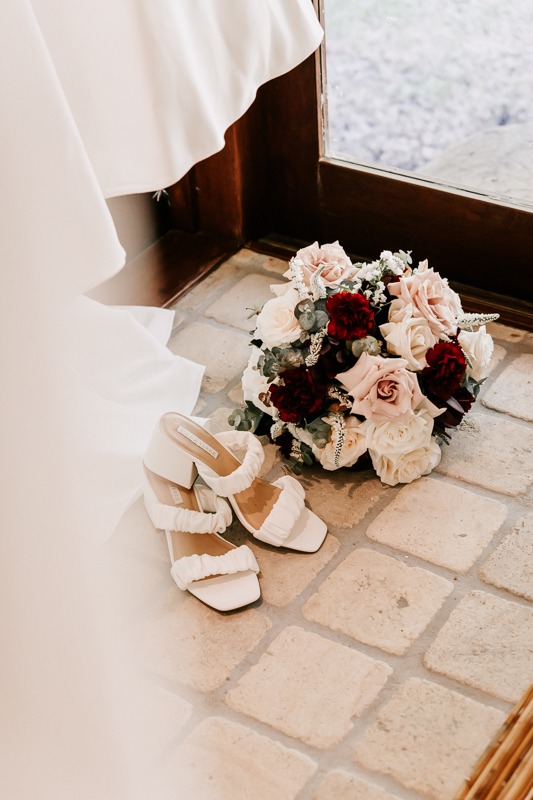 Brides bouquet, shoes and gown