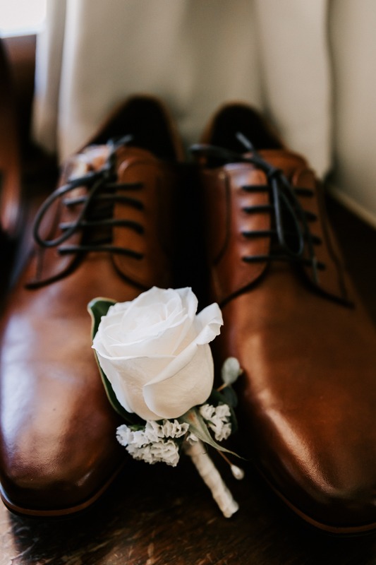 Grooms shoes and buttonhole