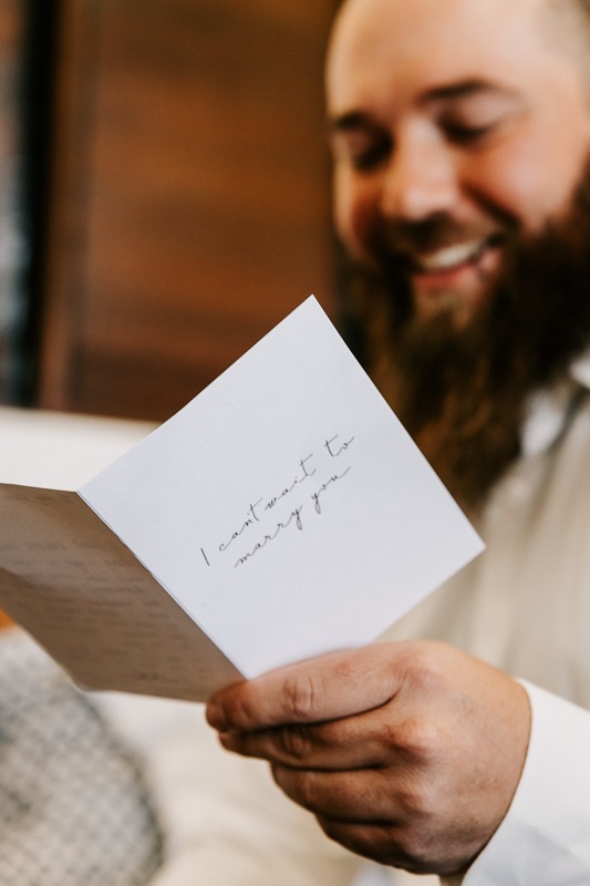 Groom reads card from Bride