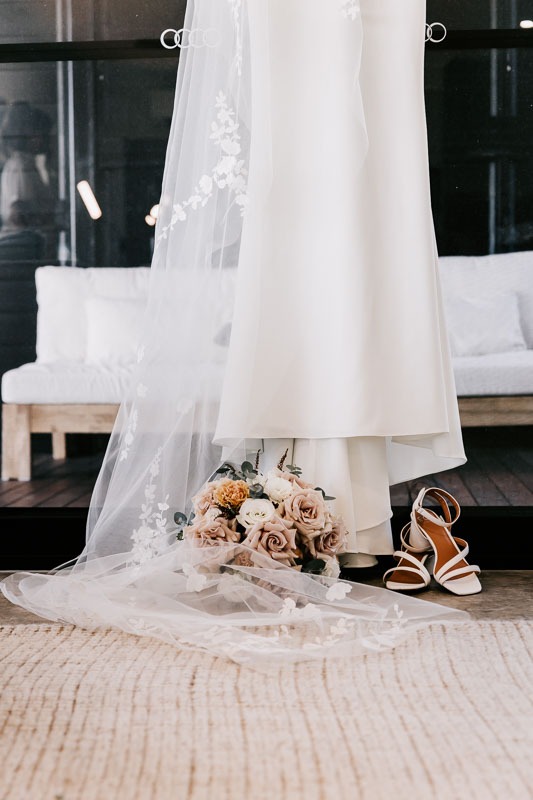 Brides gown, shoes, and bouquet
