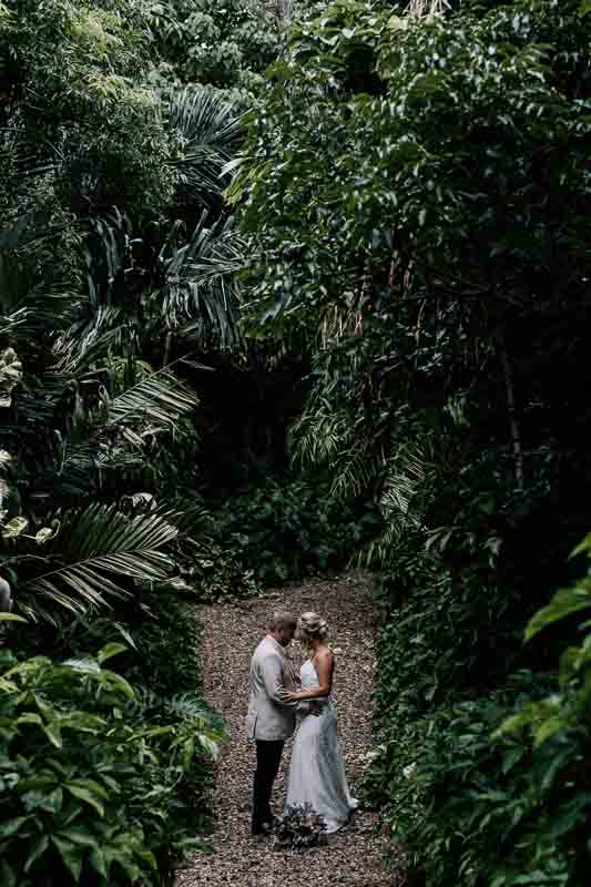 Bride & Groom embrace in rainforest