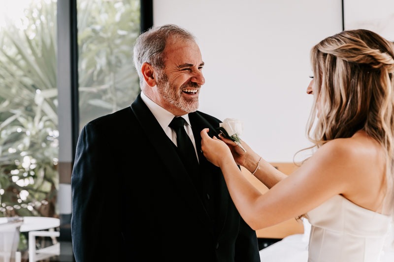 Bride putting on Fathers buttonhole