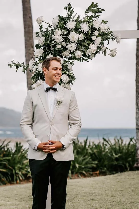Groom awaiting Bride at arbor