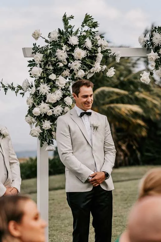 Groom awaits Bride at arbor