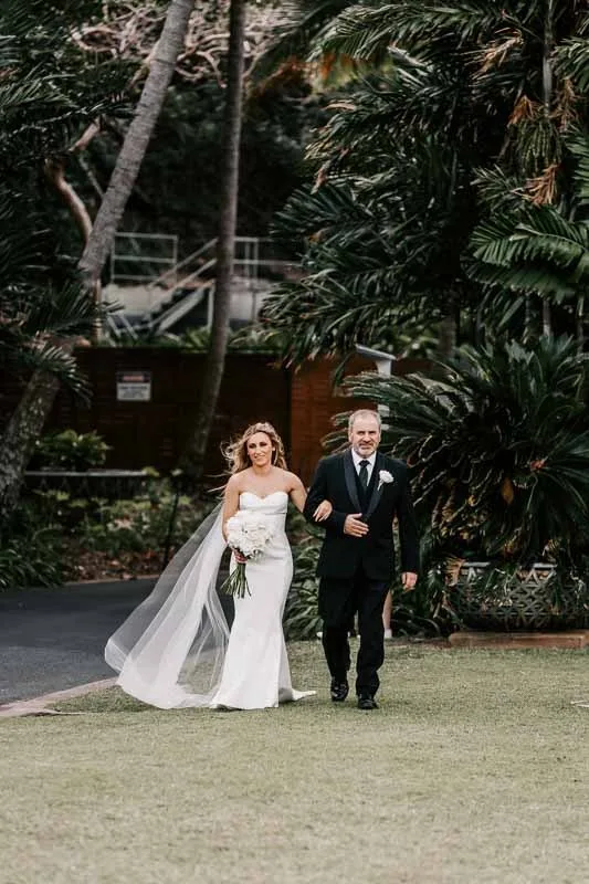 Bride walks to arbor with Father