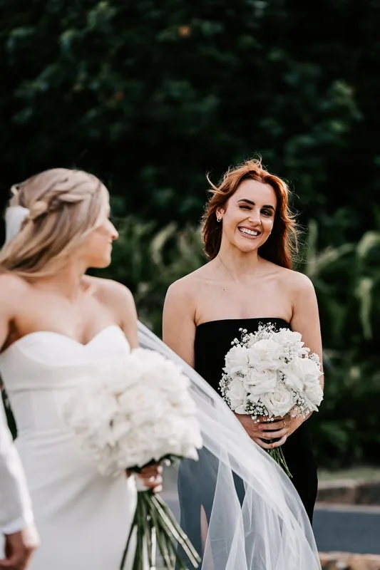 Bridesmaid winks at Bride