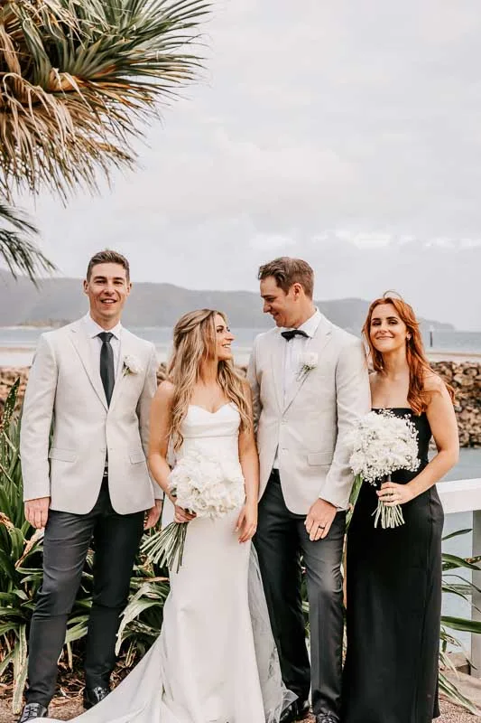 Bride & Groom smile at each other with bridal party