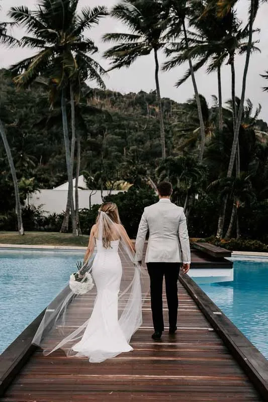 Bride & Groom walk on boardwalk