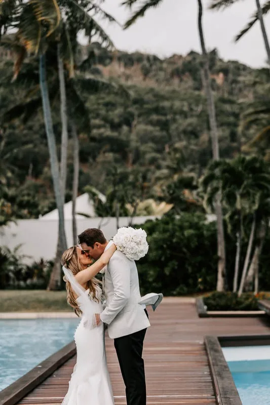 Bride & Groom kiss on boardwalk