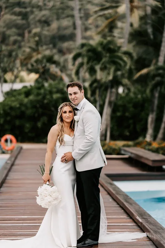 Bride & Groom embrace on boardwalk