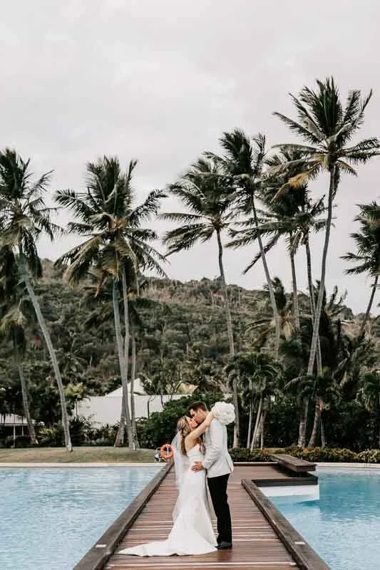 Bride & Groom kiss on boardwalk