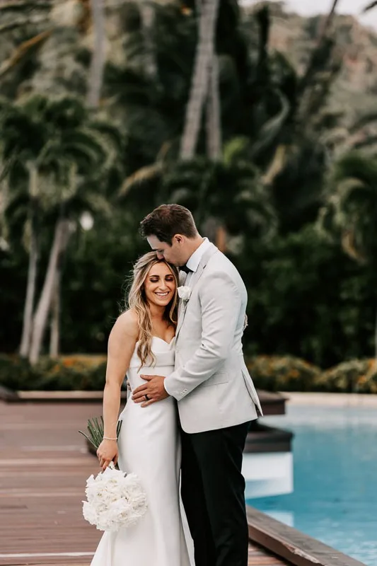 Bride & Groom embrace on boardwalk