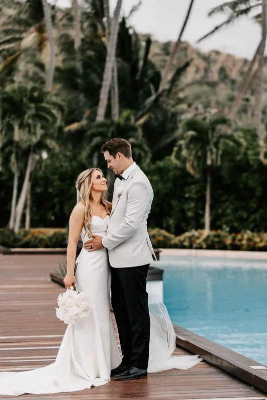 Bride & Groom look at each other on boardwalk