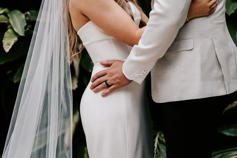 Grooms hand on Brides hip