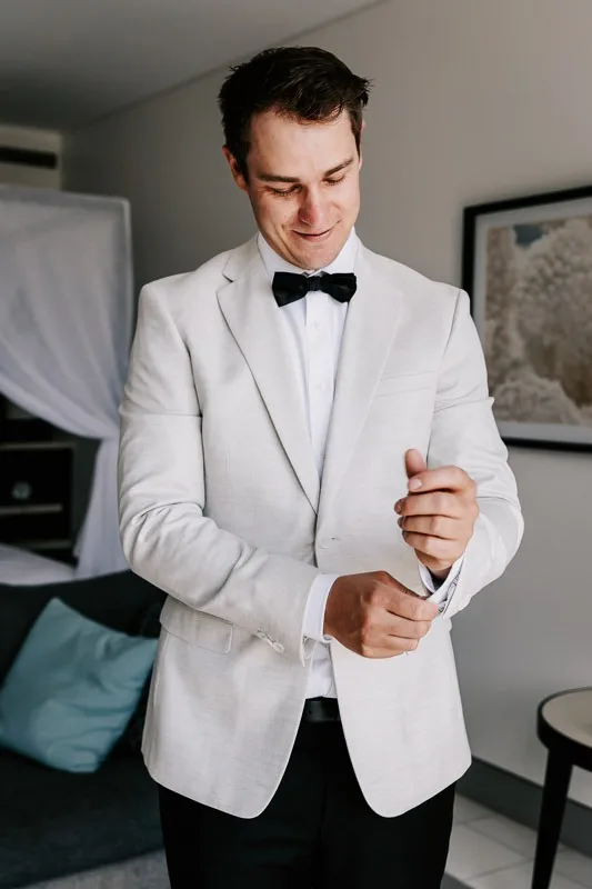 Groom adjusting cuffs