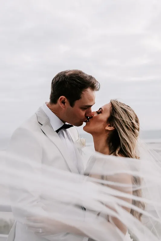 Bride & Groom kiss with veil