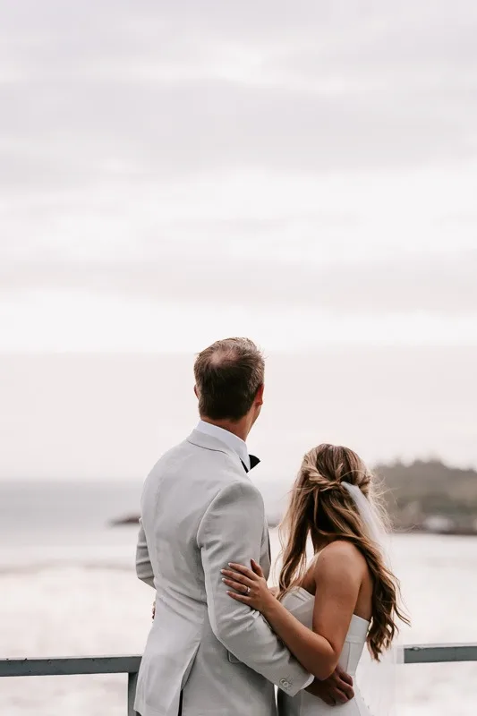 Bride & Groom look towards ocean