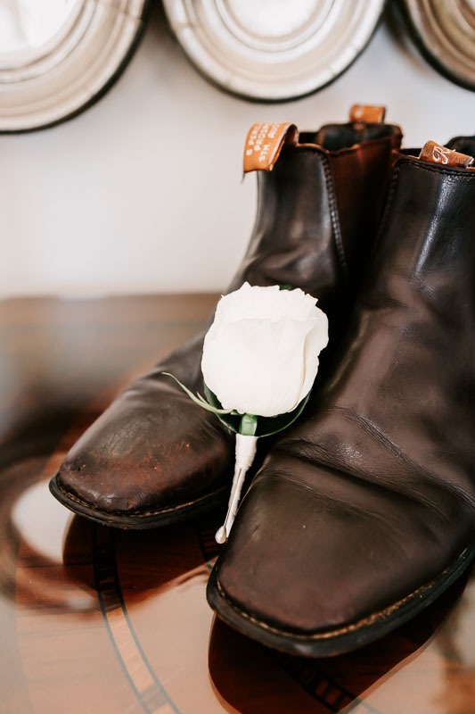 Grooms buttonhole and boots