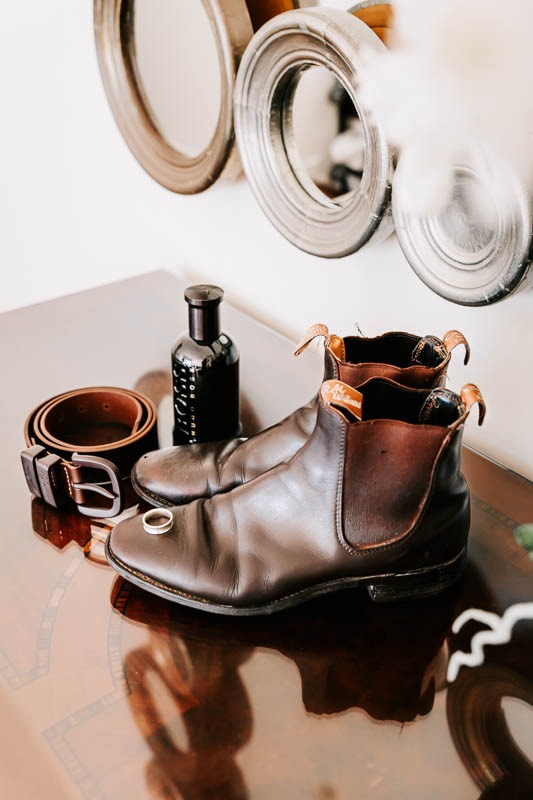 Grooms boots, belt and cologne