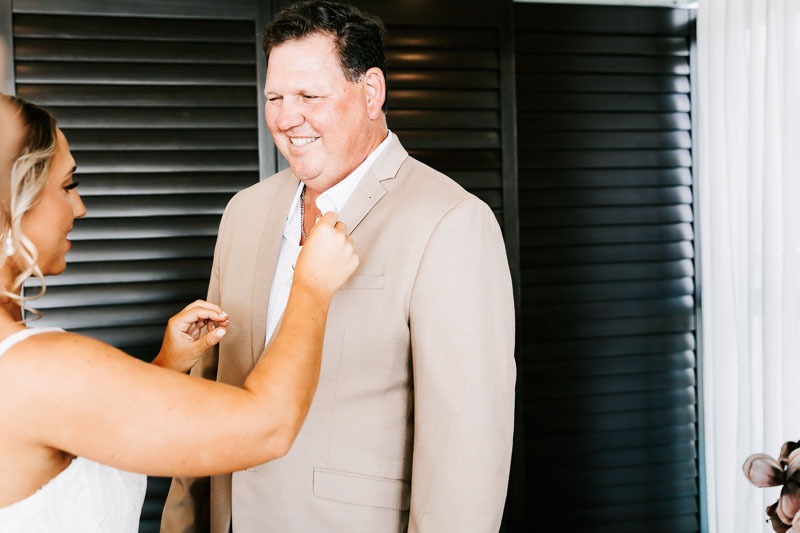 Bride putting on fathers buttonhole