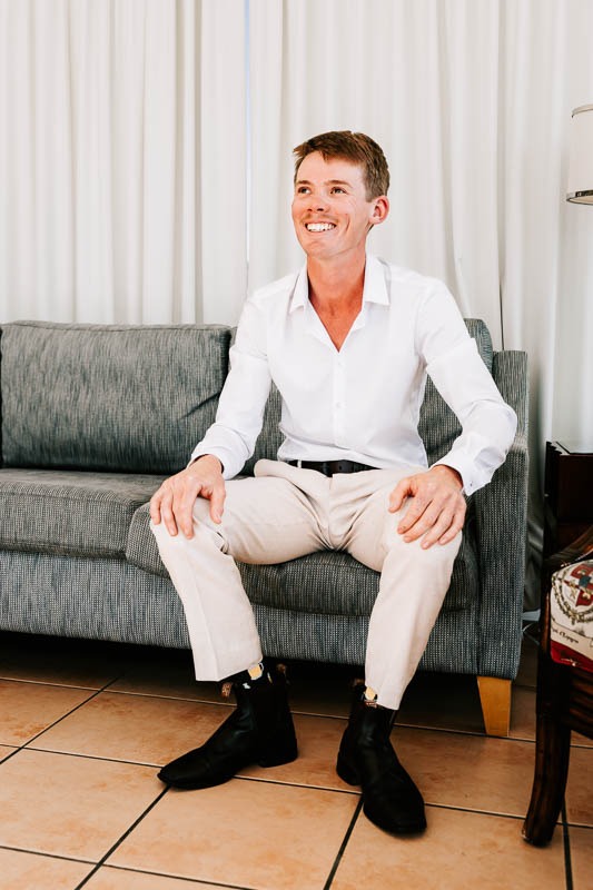 Groom sitting on couch