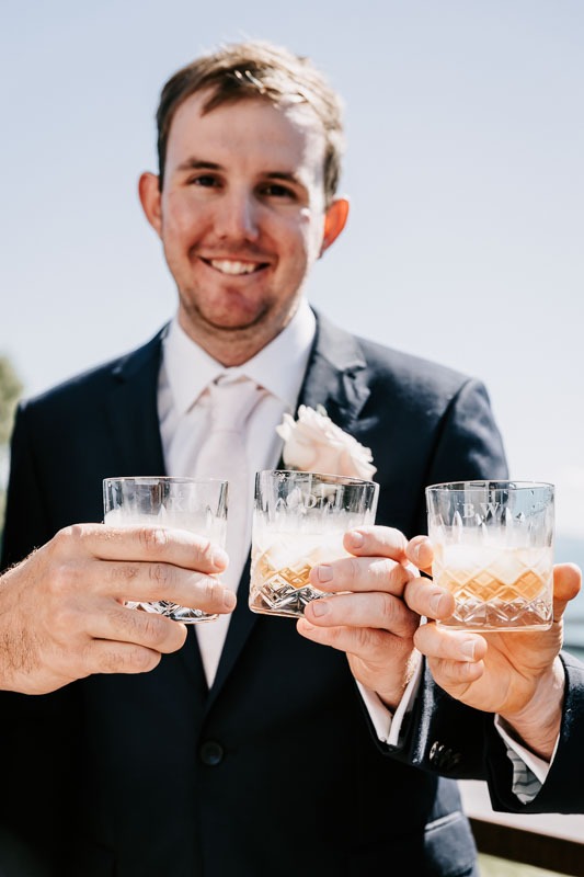 Groom smiling and cheers glasses