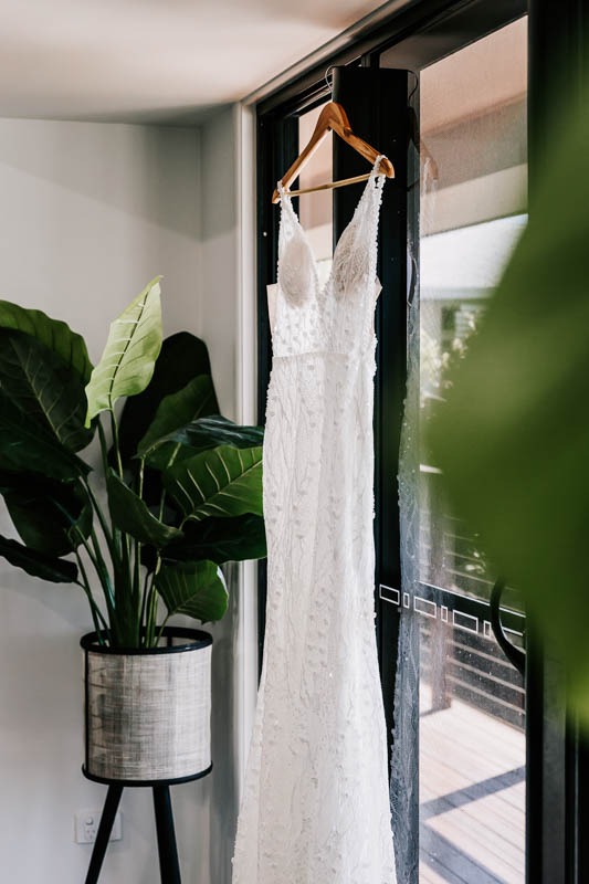 Brides gown hanging in window