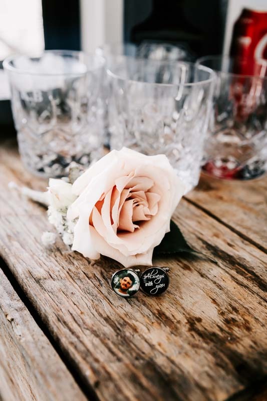Grooms cuff links, buttonhole and glasses