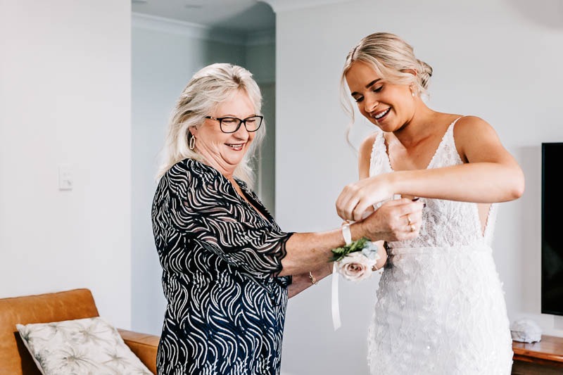 Bride putting on Mothers corsage