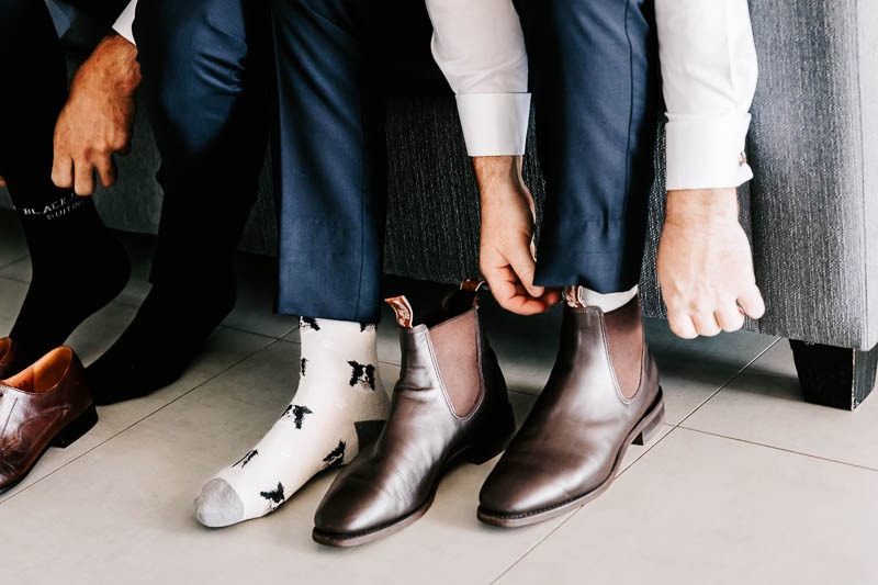 Groom putting on boots