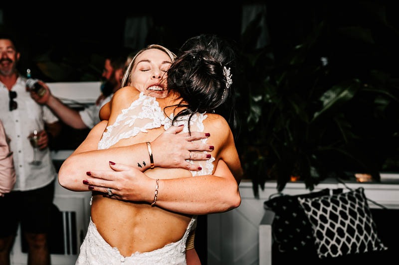 Bride embracing friend