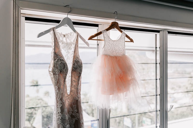Brides gown and flowergirl dress hanging