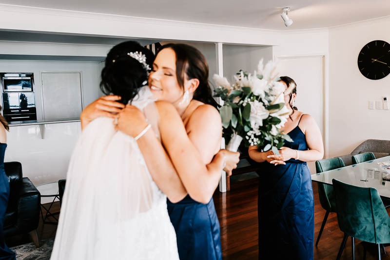 Bride hugs bridesmaids