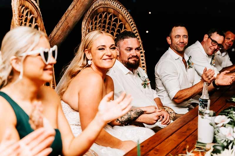 Bride & Groom smile at table at reception