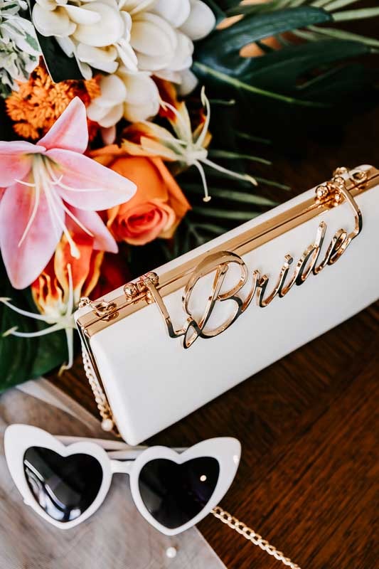 Bride handbag, sunglasses and bouquet