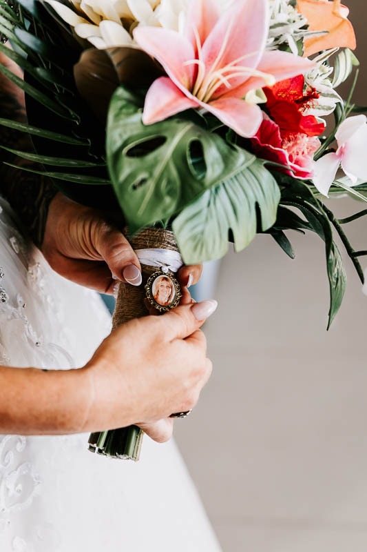 Bride showing bouquet pin