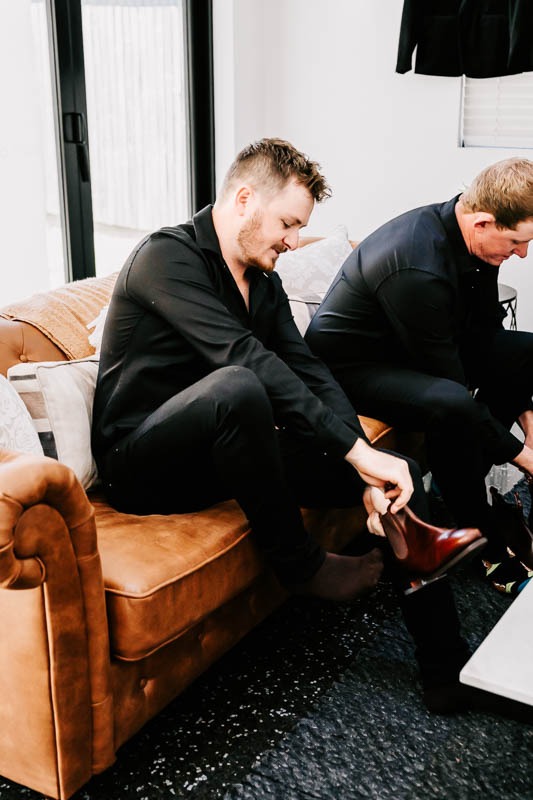 Groom putting on shoes