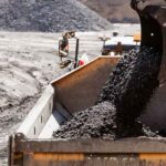 Digger scoop loading coal onto haul truck