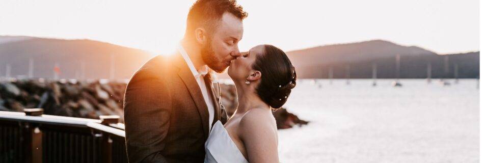 Professional videography capturing a couple's romantic sunset kiss