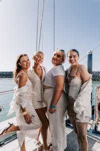 FCTA May22-Th3rd Dimension Media-LR-64 Flight Centre staff posing together on deck at Coral Sea Marina retreat