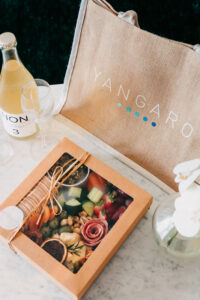 YGRO-Babymoon-TDM-LR-1 Welcome pack with Yangaro tote, white wine, and luxury grazing platter in Whitsundays villa