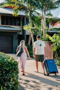 YGRO-Babymoon-TDM-LR-2 Couple walking toward Yangaro villa with suitcase during babymoon retreat