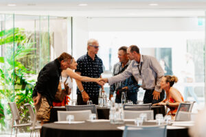 Professional videography filming group meeting in modern space